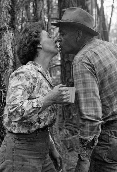 Mildred Cooper, a 43 year old grandmother and truck driver, kisses her husband by Ted Spiegel