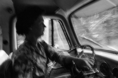 Mildred Cooper, a 43-year-old grandmother, is a truck driver with a logging truck by Ted Spiegel