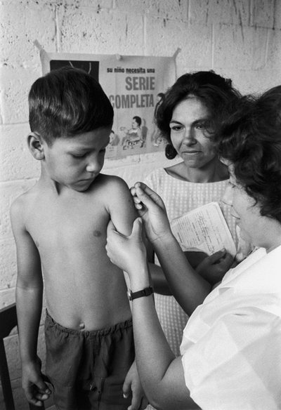 Nurse inoculates an Ecuadorian boy with vaccine on mission from the hospital ship SS Hope by Ted Spiegel