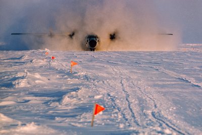 Obscured in smoke, supply plane lands on Arlis II