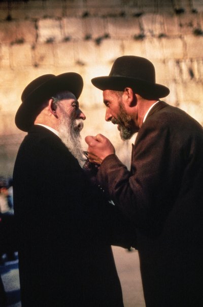 Orthodox Hasidic Jewish men discuss fine points of law at the Western Wall by Ted Spiegel