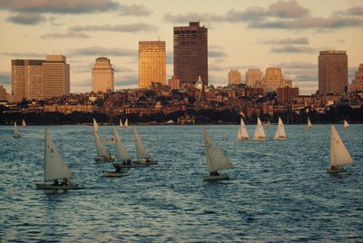Sailboats at sunset in Charles River Basin, below Beacon Hill by Ted Spiegel