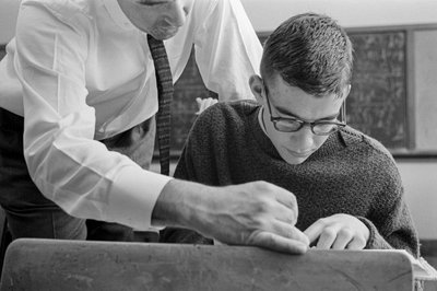 Teacher helping student with text at James A. Garfield High School by Ted Spiegel