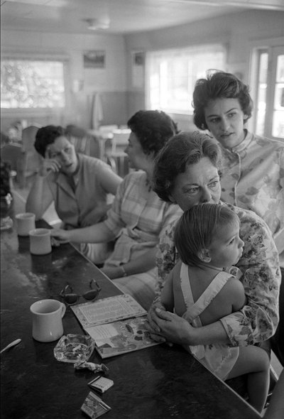 Women at a counter chat over breakfast in a diner in Oregon by Ted Spiegel