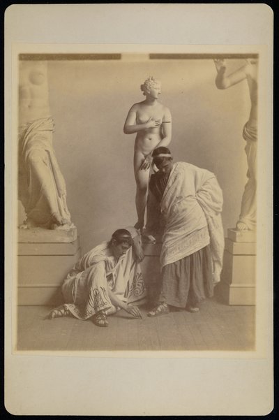Two Male Students in Grecian Costume Before a Plaster Cast of Aphrodite in the Cast Room of the Pennsylvania Academy by Thomas Eakins