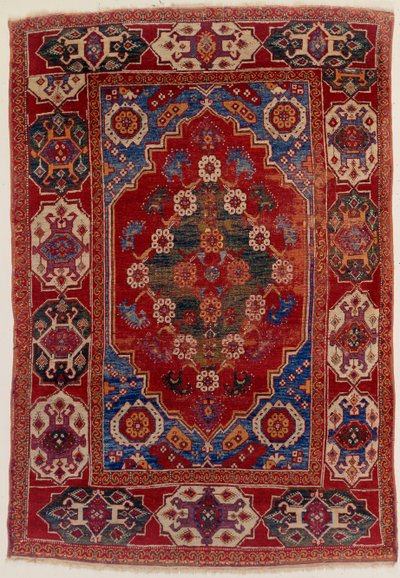 A Transylvanian Rug with Floral Motifs on a Brick Red Background by Transylvannian School