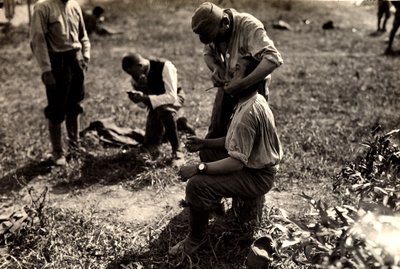 Austrian prisoners during World War I in Bagnaria Arsa, Udine, Italy; in the foreground a soldier shaves a fellow soldier, 02/04/1916 by Ugo Ojetti