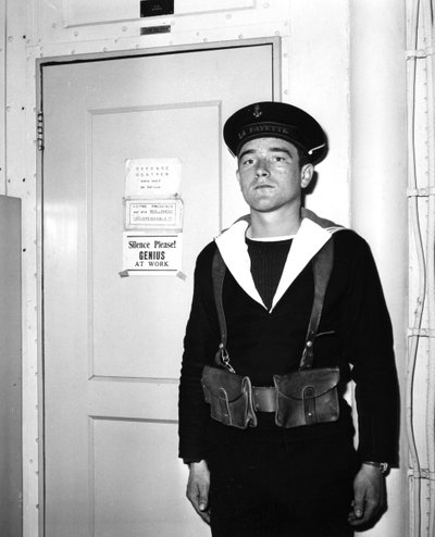 A French Sentry Outside the Operations Room of the Aircraft Carrier La Fayette by Unbekannt