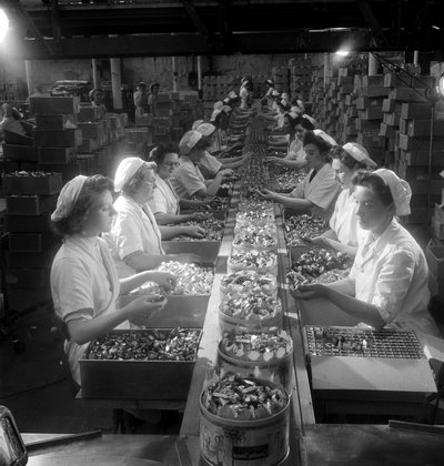 A line of female workers pack 