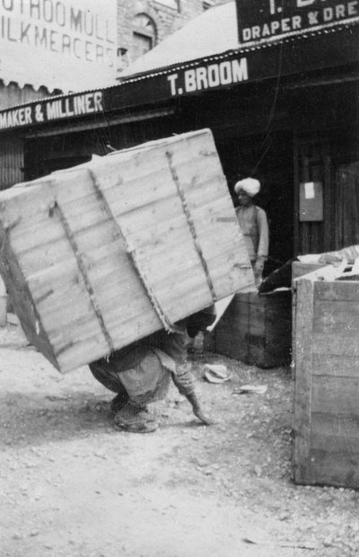 A porter lifting a large load, Chakrata, India by Unbekannt