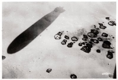 Aerial view of a desert settlement, with a shadow cast by a Zeppelin by Unbekannt