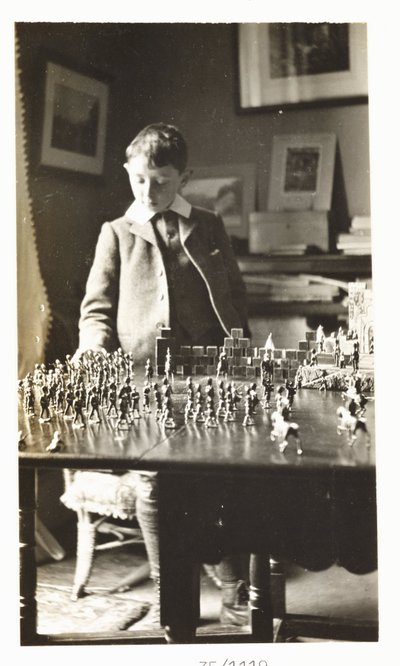 Boy playing with toy soldiers, c 1912 by Unbekannt
