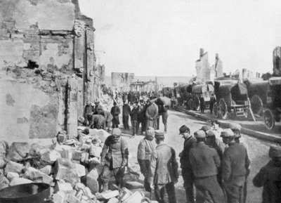 Captive German prisoners removing debris from the streets of Clermont-en-Argonne, France by Unbekannt
