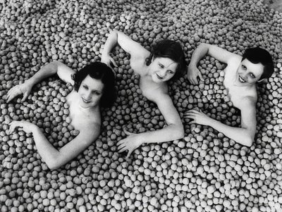 Three Young Women Bathing in a Sea of Walnuts by Unbekannt