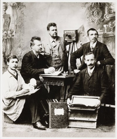 Group of photographers and assistants with equipment by Unbekannt