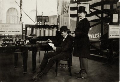 Lee DeForest (seated) sending a wireless telephone message in the Department of Electricity at the 1904 World