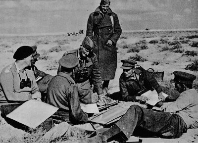 Maps and plans are spread on the sand by Unbekannt