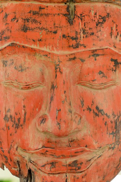 Old Wooden Buddha. Offerings at Wat Phnom Temple by Unbekannt