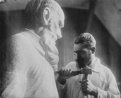 Russian sculptor Sergey Merkurov 1881-1952 working on his statue of Leo Tolstoy by Unbekannt