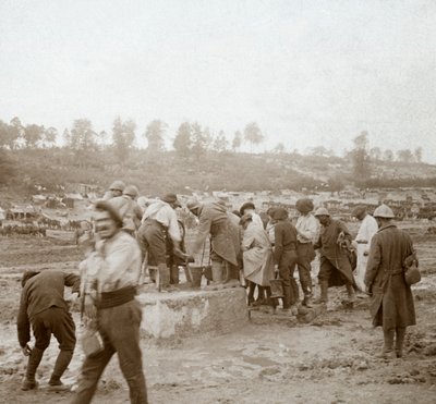 Soldiers queuing in the mud for water, Genicourt, northern France by Unbekannt