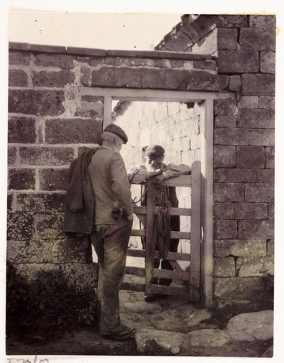 Two men talking over a gate, c 1905 by Unbekannt