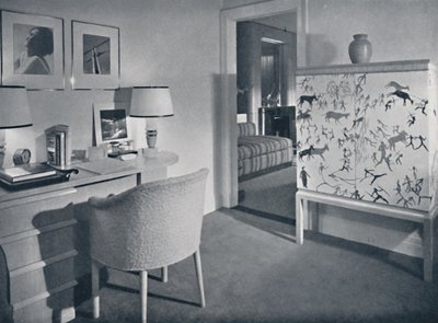 W. & J. Sloane. Photographers hobby room showing a desk in natural oak, a hand-woven covering on the table by Unbekannt