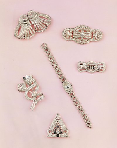 Selection of diamond jewellery: baguette and marquise-shaped diamond spray brooch; Art Deco diamond clip; panel diamond brooch; lady