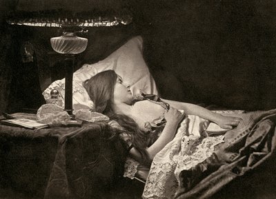 A young woman sleeping on candid embroidered sheets in a bed by Unbekannter Künstler