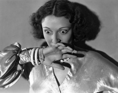 Hollywood, California: c.1932 Close-up of a young woman covering her mouth in fright by Unbekannt