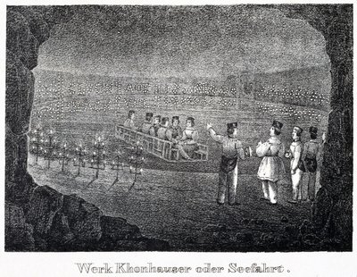 Salt mine: a group of visitors crossing the underground salt lake of the mine on a boat, in Durrnburg, Austria by Unbekannt