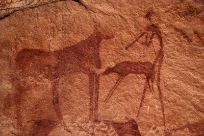 Rock art, Prehistory: Rock painting of a cow, calf and character in an ornate shelter, in the Uweinat massif, Egypt by Unbekannt