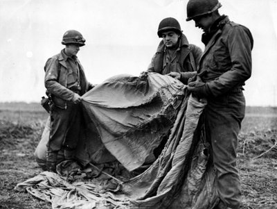 Second World War: Near Kornelmunster (Germany) 17 December 1944: Infantrymen from the 1st US Army examine a German parachute used the night before the day of Operation Guard