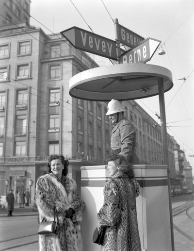 Two American young women talking to a policeman in Lausanne, 4th January 1949: With The Policeman by Unbekannt