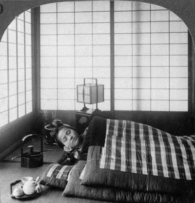 A Geisha Sleeping in a Tea House, Hikone, Japan by Underwood and Underwood