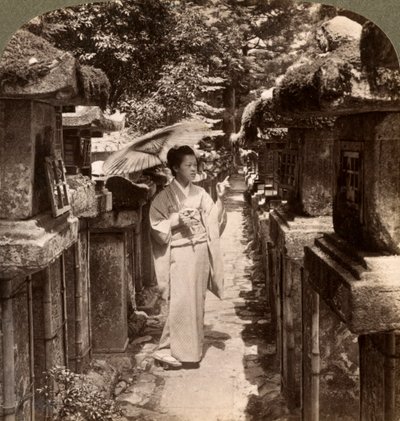 A Woman Shinto Devotee Counting the Stone Lanterns, Kasuga Shrine, Nara, Japan by Underwood and Underwood
