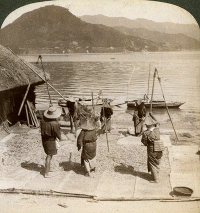Flailing Barley Beside a Fishing Beach on the Inland Sea, Japan by Underwood and Underwood