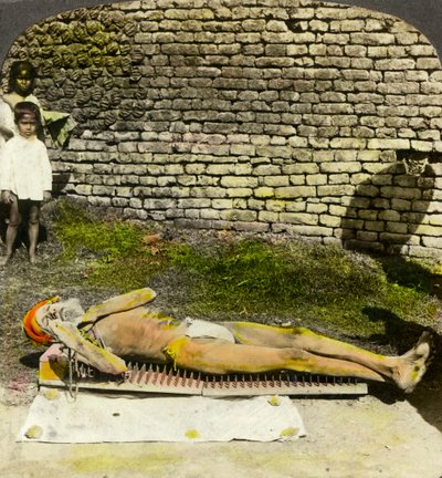 Hindu devotee on a bed of nails near the shrine of Kali, Calcutta, India, early 20th century by Underwood and Underwood