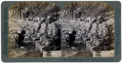 Peasant Praying Before a Row of Statues of the God of Light, Daiya River, Nikko, Japan, 1904 by Underwood and Underwood