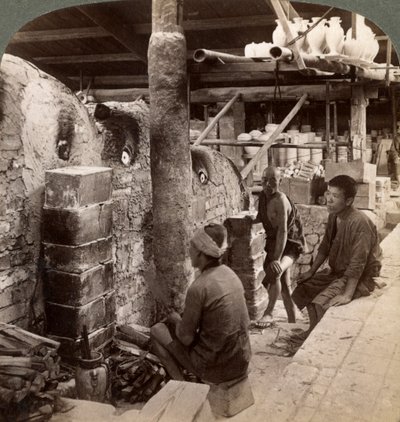 Workmen watching kilns full of Awata porcelain, Kinkosan works, Kyoto, Japan, 1904 by Underwood and Underwood