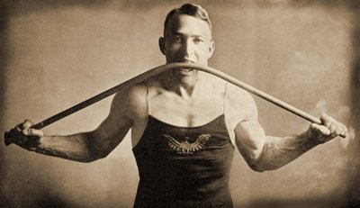 Californian Strongman Mr. P. A. Linebarger bends an iron bar with his teeth, San Francisco c.1922 by Unknown