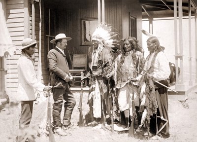 Three Cheyenne dressed in ceremonial costume and wearing guns greet a White accompanied by an interpreter by Unknown artist