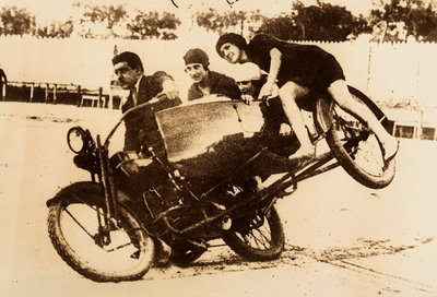 Man Driving a Motorcycle with a Sidecar Carrying Three Young Women by Unknown photographer