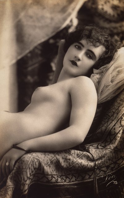 A Young Woman Posing Nude on a Couch by Unknown photographer