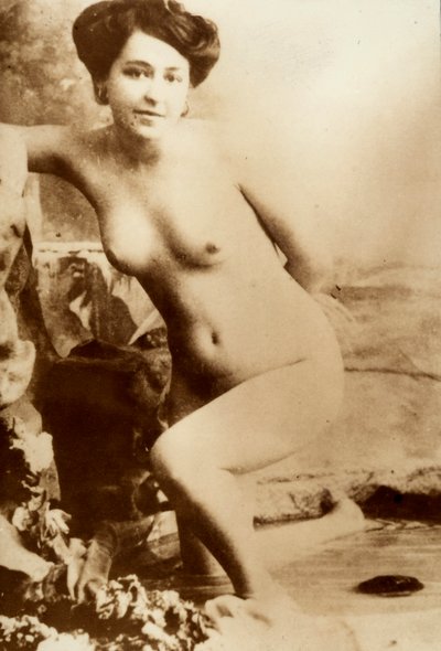 Nude portrait of a young woman getting out of a tub by Unknown photographer
