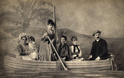 Portrait of a family with a photographer, staged in a boat. Photography, late 19th century, Paris. Coll. Selva by Unknown photographer