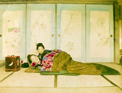 Reclining on a Futon. Two Japanese Women Recline on a Traditional Futon Placed on the Floor. Japan, circa 1910. by Unknown photographer