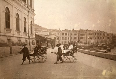 Two men carried by rickshaw in Hong Kong by Unknown photographer