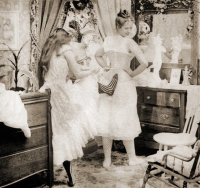 Reducing the Surplus, stereoscopic card depicting a young woman being laced into a corset, c.1900 by Vermont, USA H.C. White Company