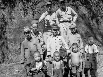American soldiers with Japanese family pose together after Japanese surrender by Volkmar Wentzel