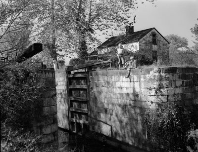 Antique lock on or near the Potomac River is viewed by boys by Volkmar Wentzel